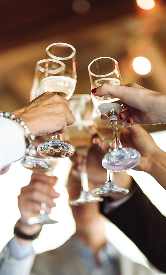 a group of people clinking wine glasses