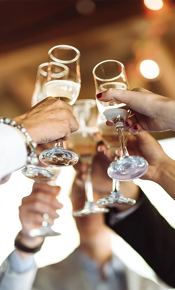 a group of people clinking wine glasses
