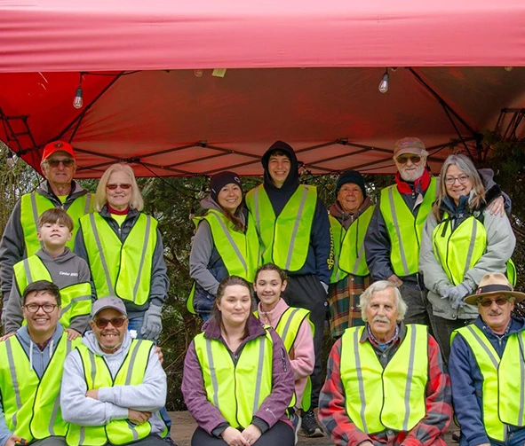 a group of people in yellow vests