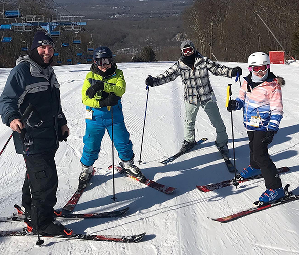 a group of people on skis posing for a photo