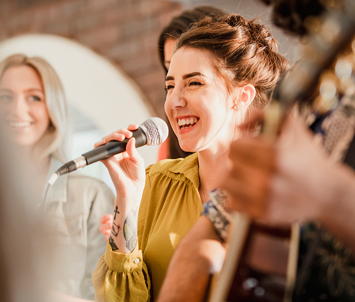a woman singing into a microphone