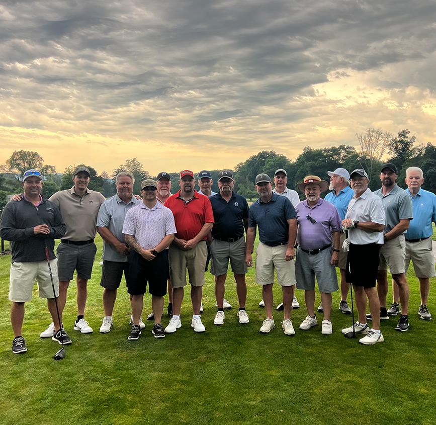 a group of men standing on a golf course
