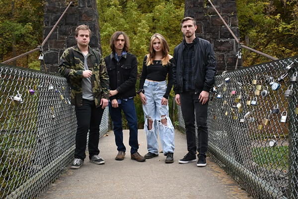 a group of people, Smooth Retsina Glow standing on a bridge