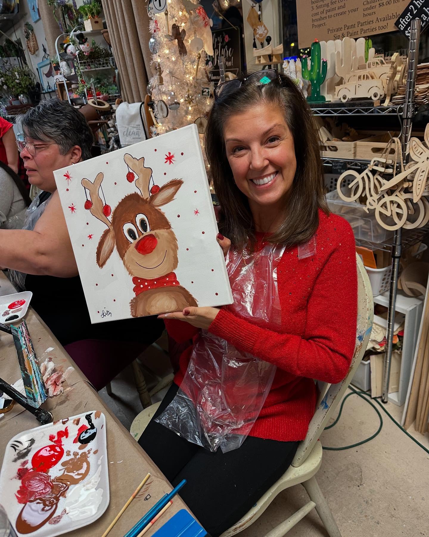 a woman holding a painting