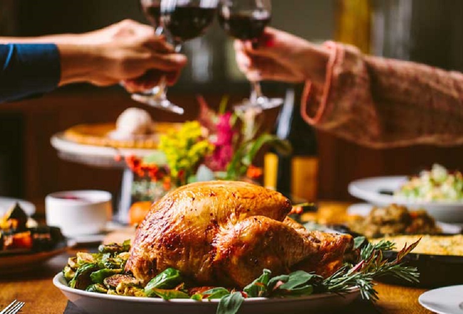 a turkey on a plate with wine glasses