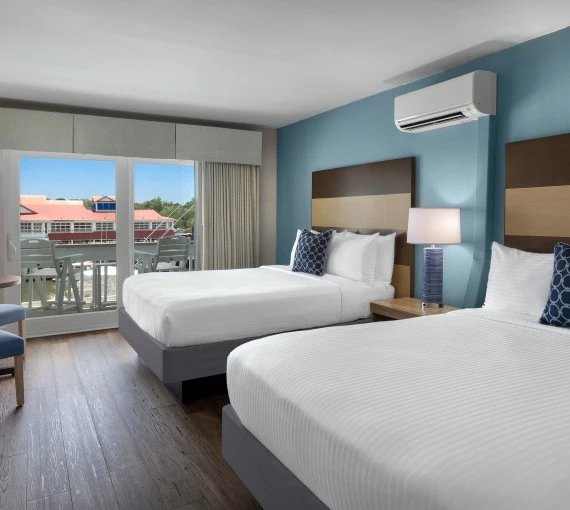 a room with two beds and a balcony