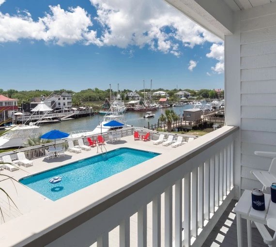 a pool on a balcony overlooking a harbor