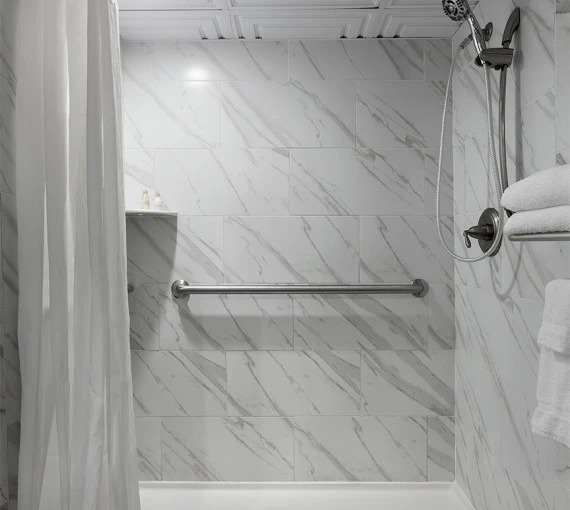 a shower with a white shower curtain
