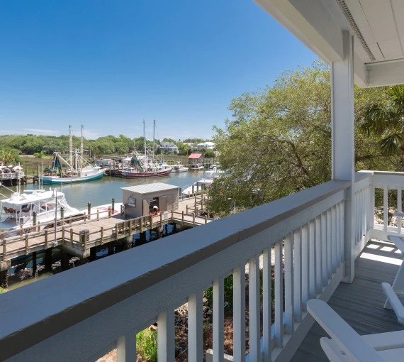 a deck with a view of boats and a dock