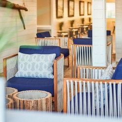 view of a seating area with dark blue cushions and patterned decor pillows