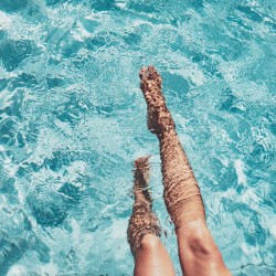view of a woman's legs in a pool