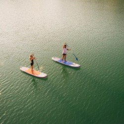 two people paddle boarding