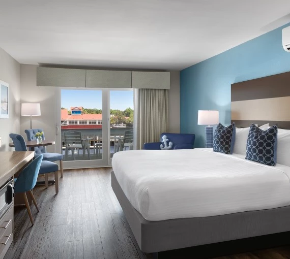 a room with a bed and chairs and a table