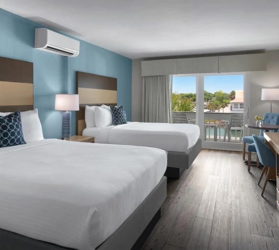 a room with two beds and a table