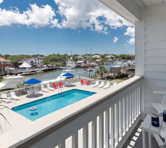 a pool on a balcony overlooking a harbor