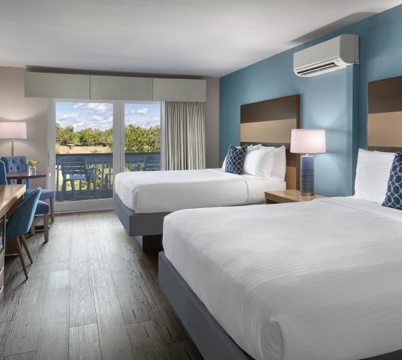 a room with two beds and a table