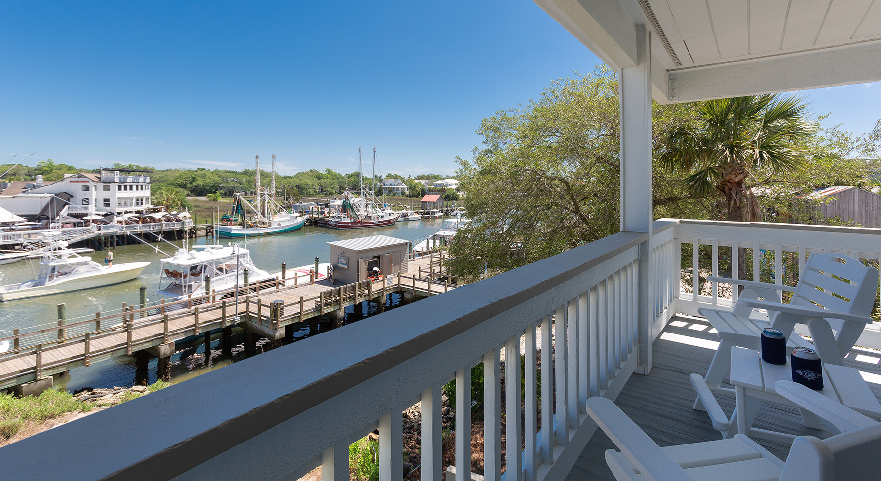 a deck with a view of boats and a dock