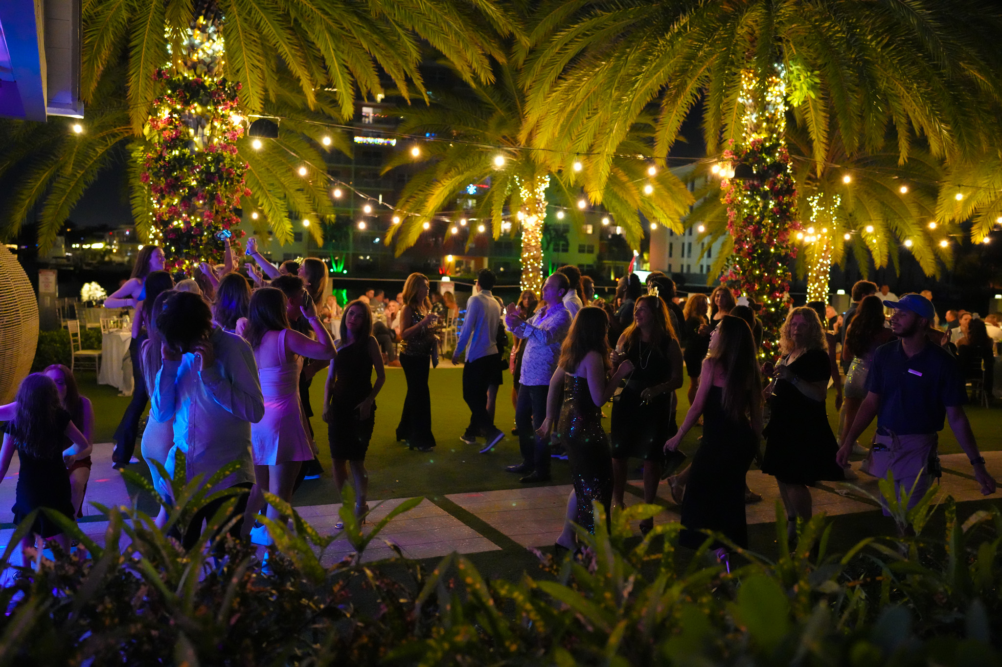 a group of people dancing in a garden