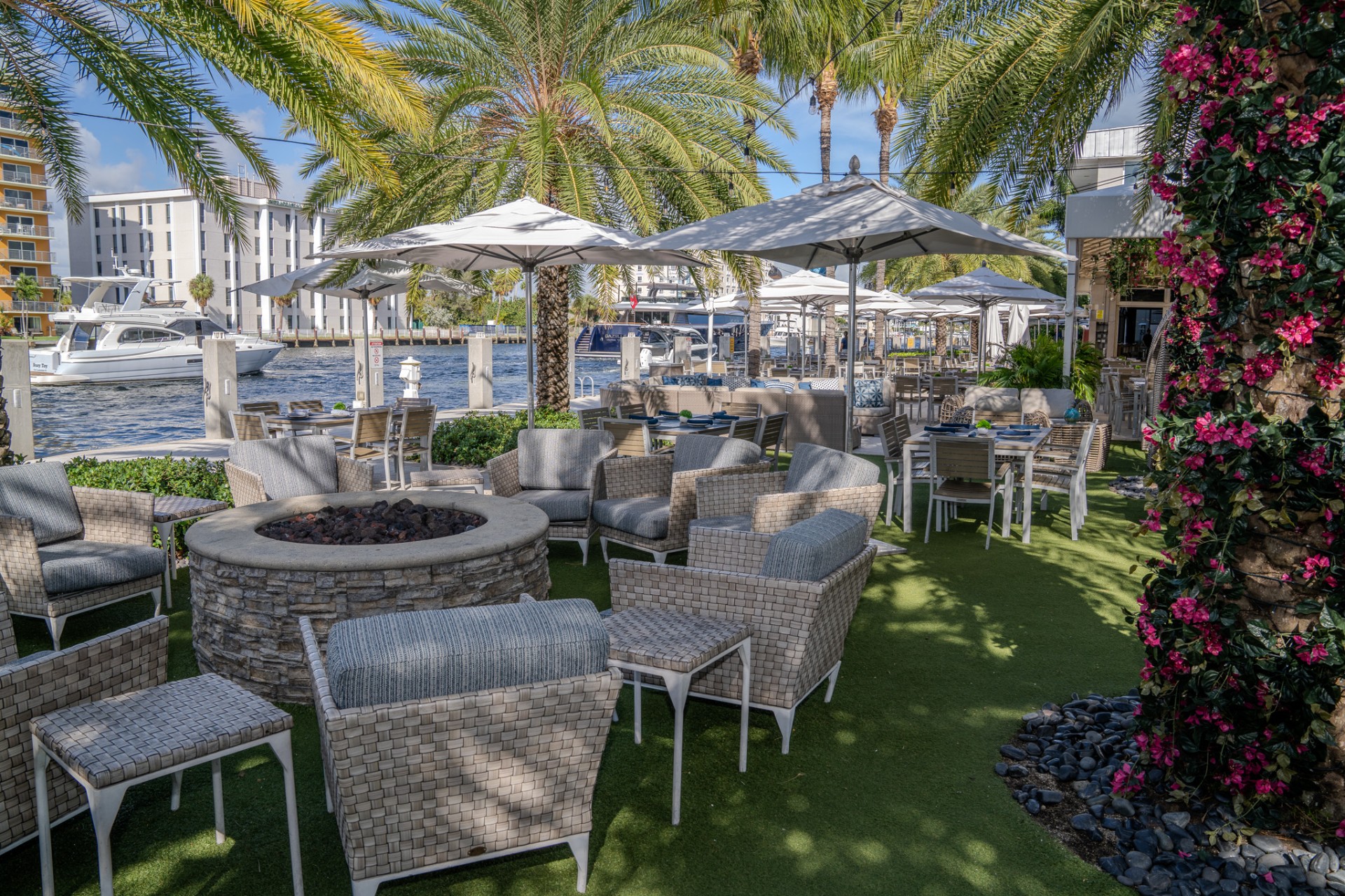 a patio area with chairs and umbrellas