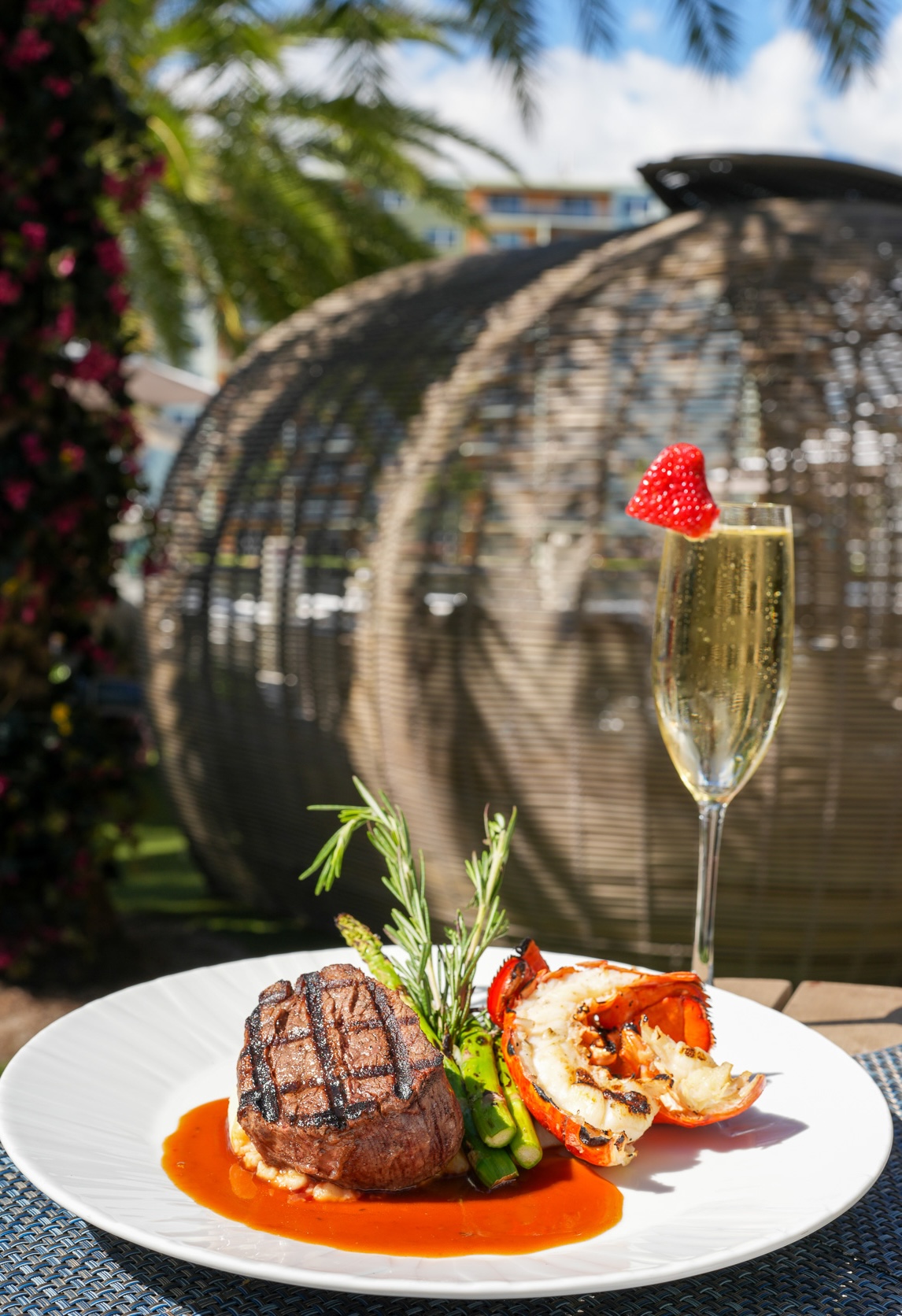 a plate of food and a glass of champagne