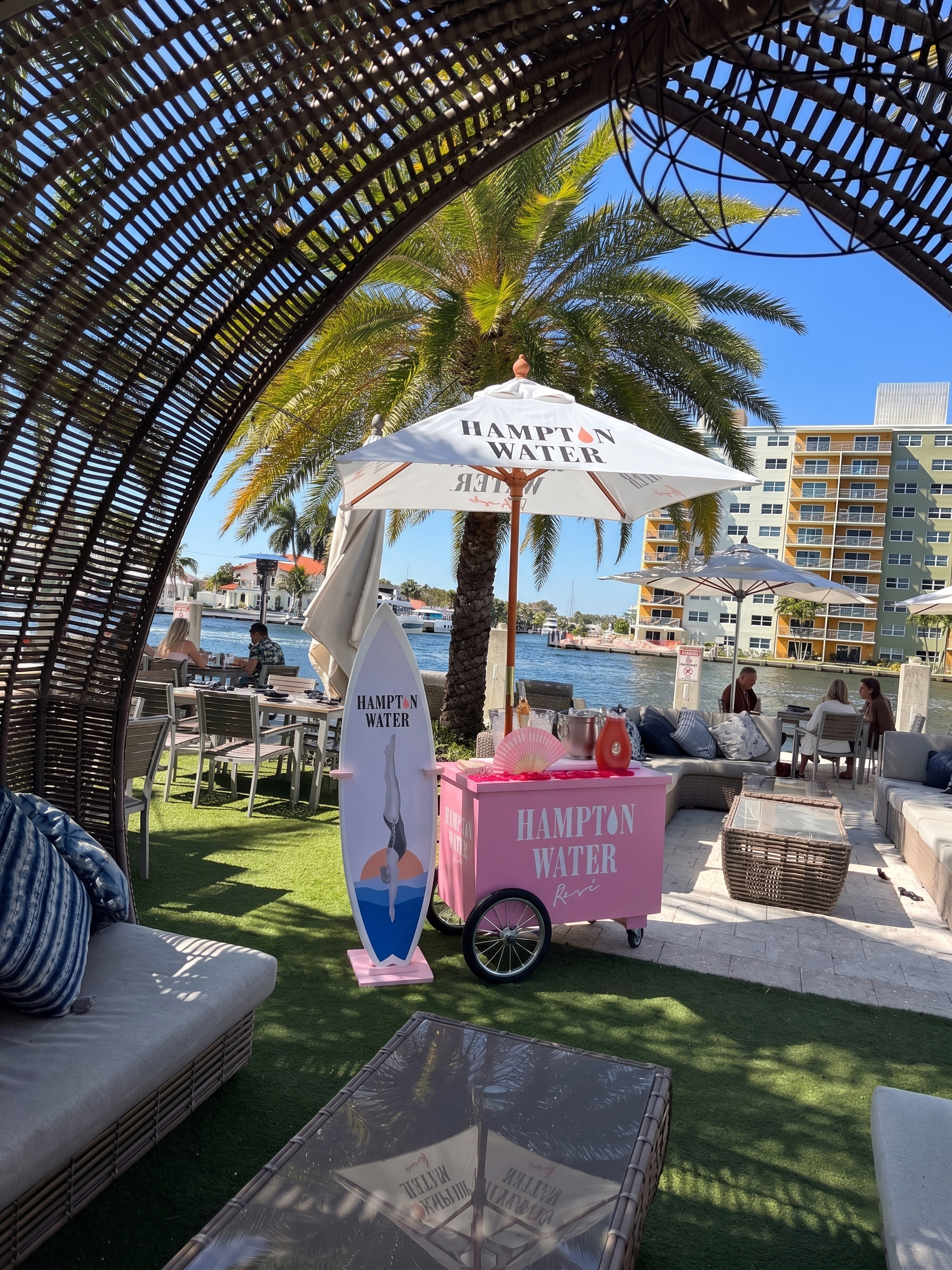 a umbrellas and a cart under a palm tree