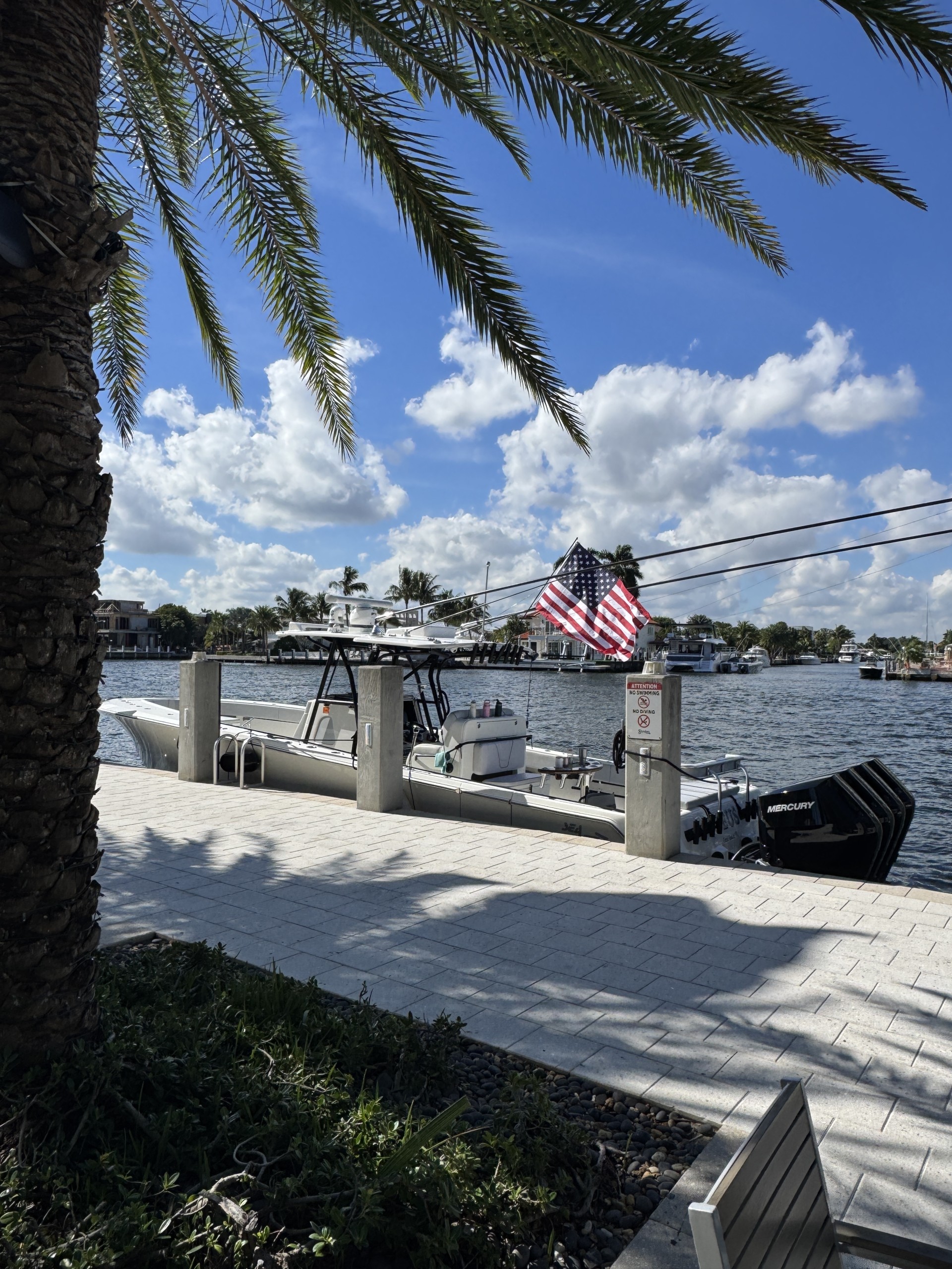 a dock with boats and a flag