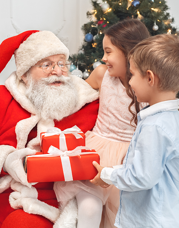 a man in a santa claus garment holding a couple of presents