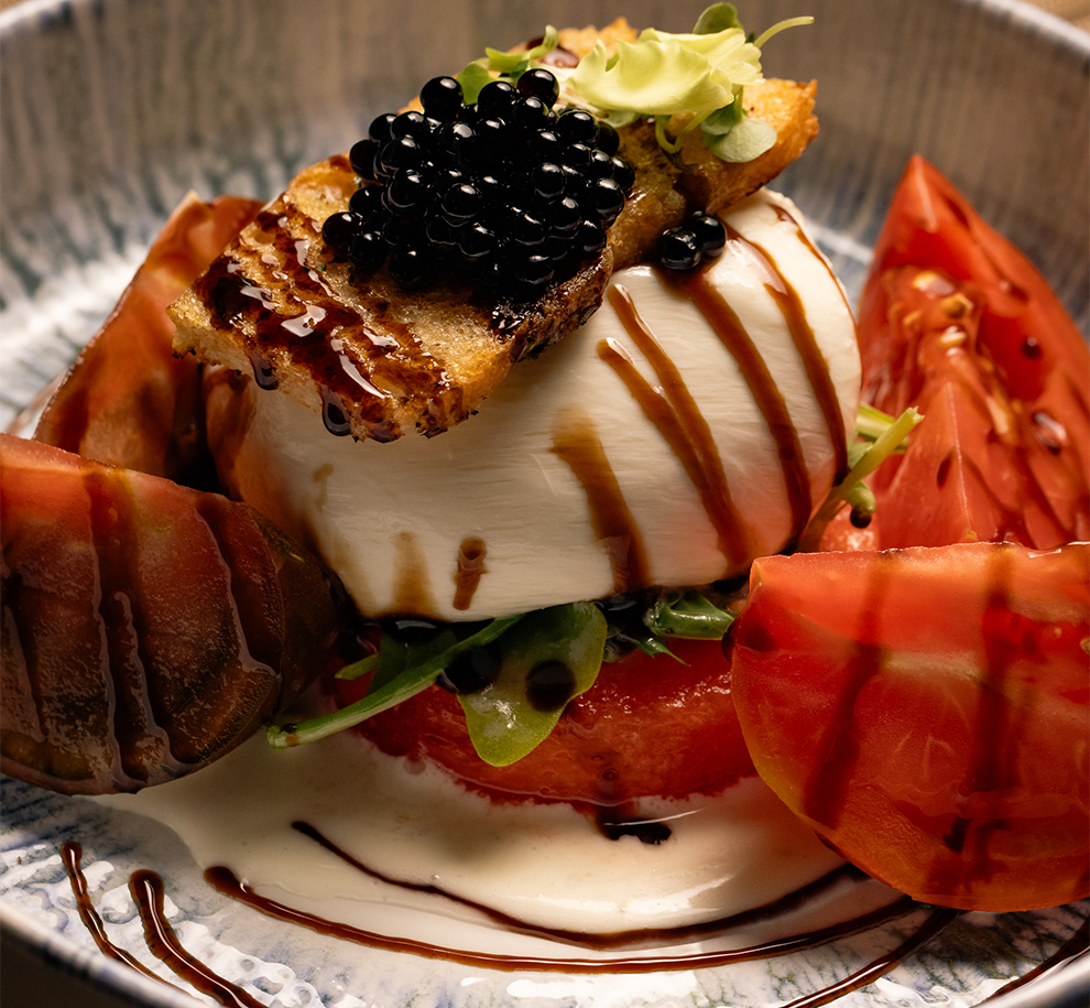 a plate of food with a sauce drizzled on top