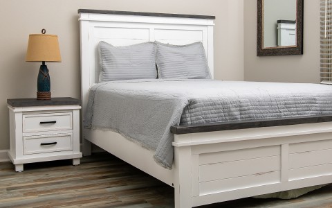 a bed with a white headboard