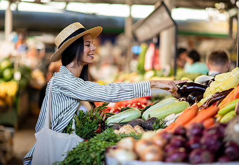 a woman in a straw hat at a market