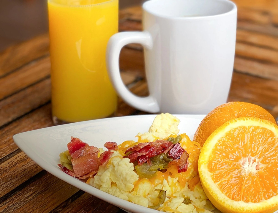 a plate of food and a mug of juice