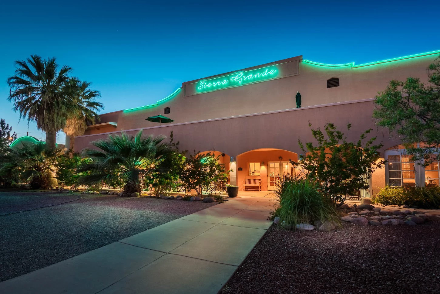 a building with palm trees and a walkway
