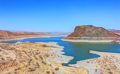 a water and sand hills
