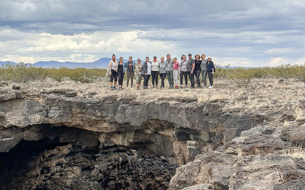 a group of people standing on a rock formation
