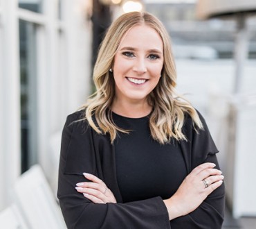 a professional headshot of Katie Records smiling at the camera