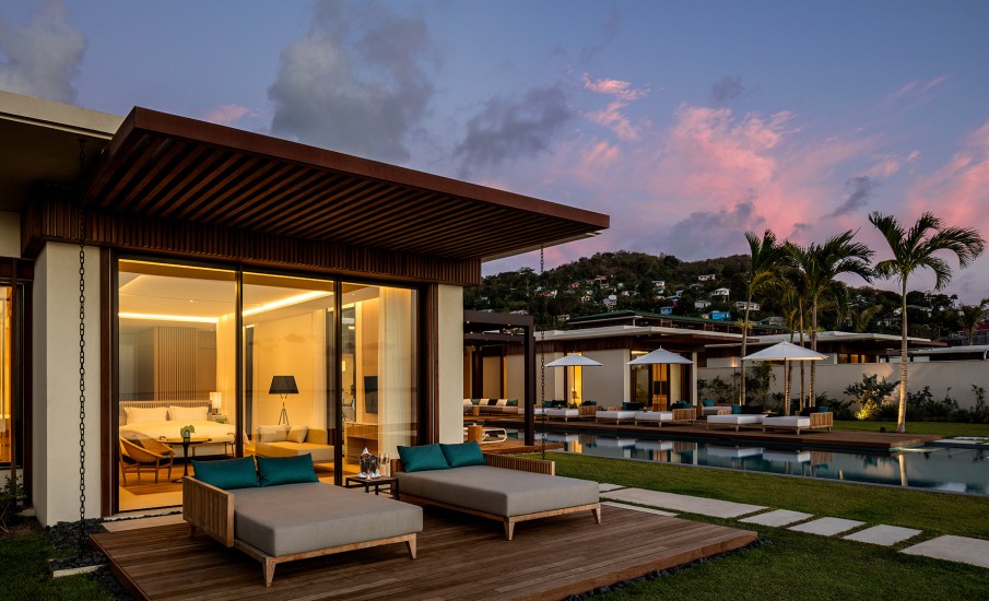 The exterior of a  private villa and pool at sunset at Silversands Grenada resort.