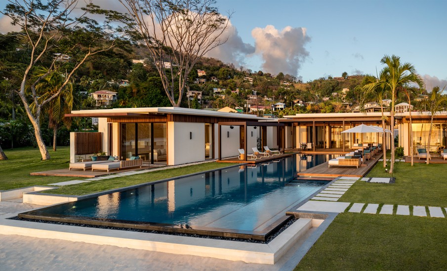 Exterior of a four-bedroom villa in Grand Anse at sunset with a private swimming pool.