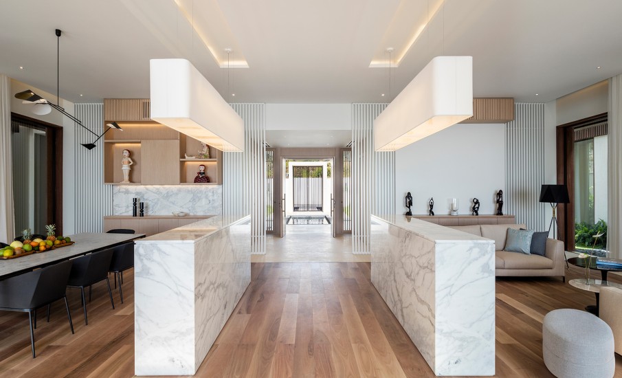 A Grand Anse villa dining room and living room separated by marble half walls at Silversands Resort.