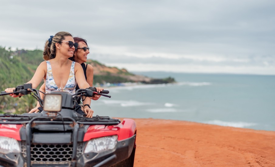 two women riding a motorcycle