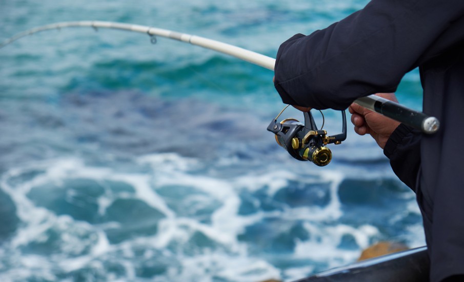 a man holding a fishing rod