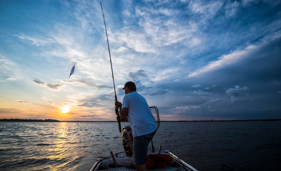 a man on a boat flying a kite