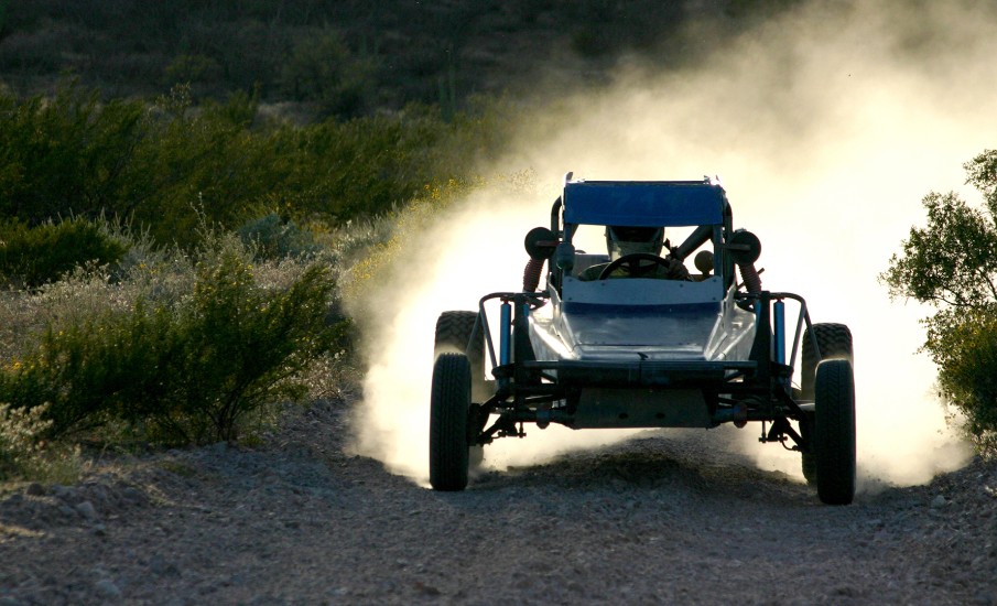 a tractor driving on a dirt road