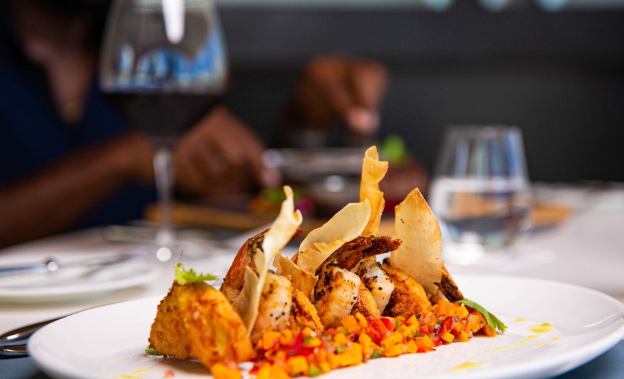 a plate of food and a glass of wine