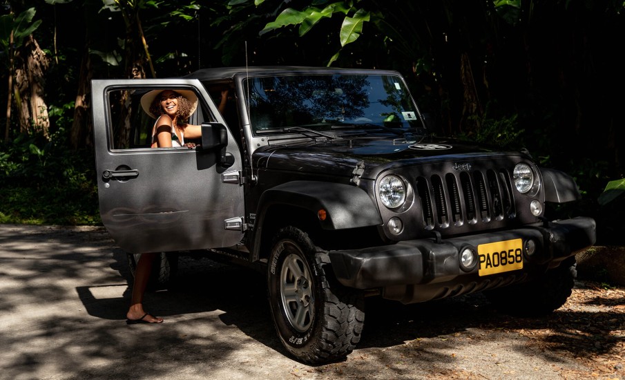 a person standing next to a black car
