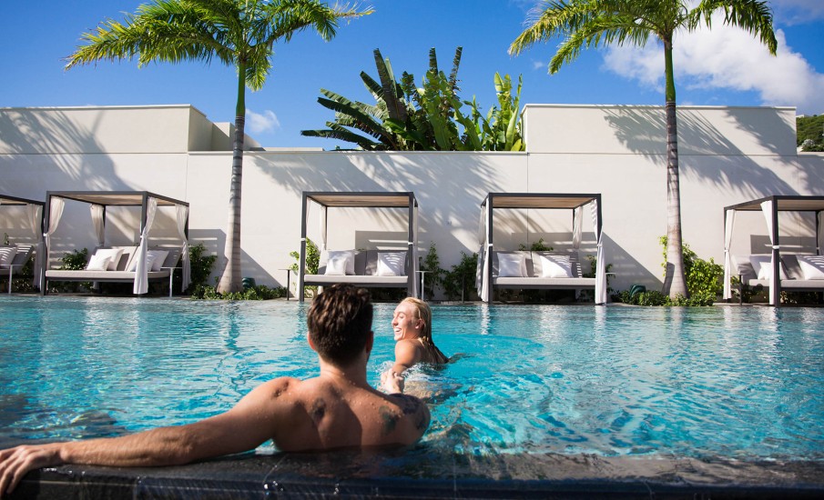 a man and woman sitting in a pool