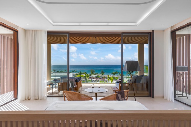 a room with a view of the ocean and a beach
