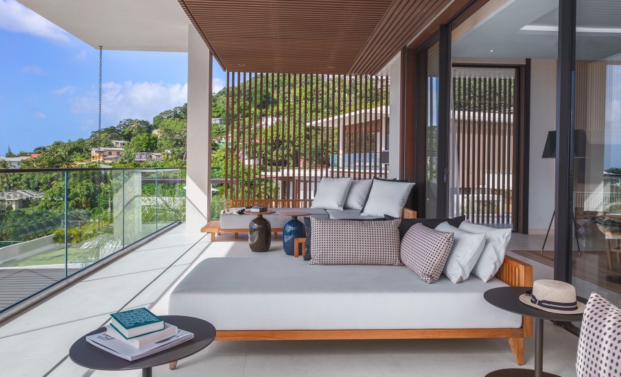 Lounge furniture on a private villa balcony overlooking the Ocean at Silversands Grand Anse resort in Grenada.