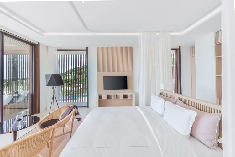 a bedroom with a bed and a tv