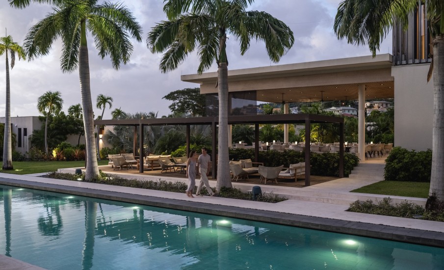 a man walking by a pool