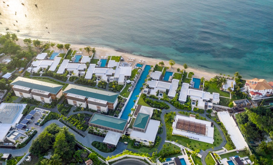 a aerial view of a resort with a pool and a beach